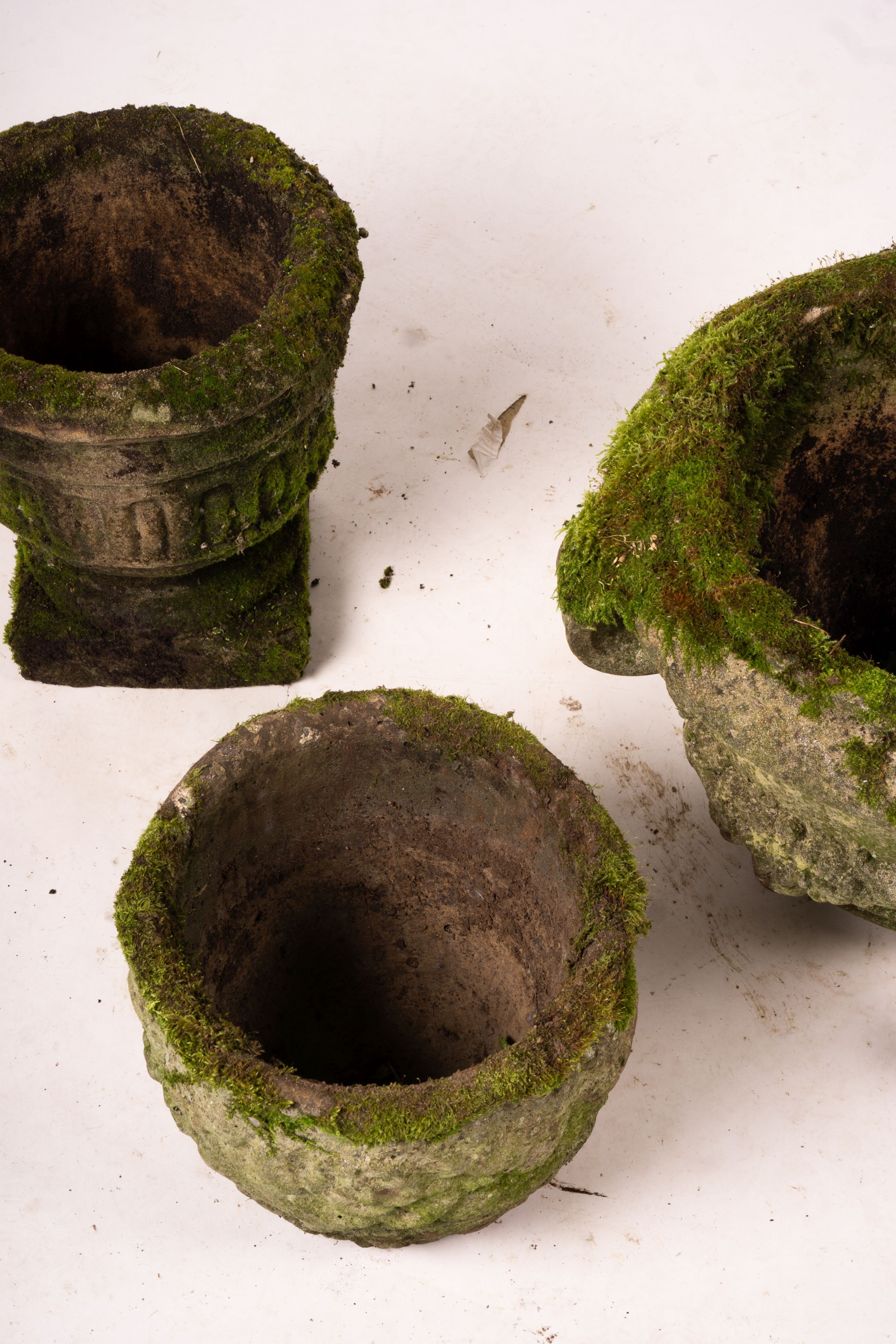 Three weathered reconstituted stone circular garden planters, largest Diam.52cm H.34cm